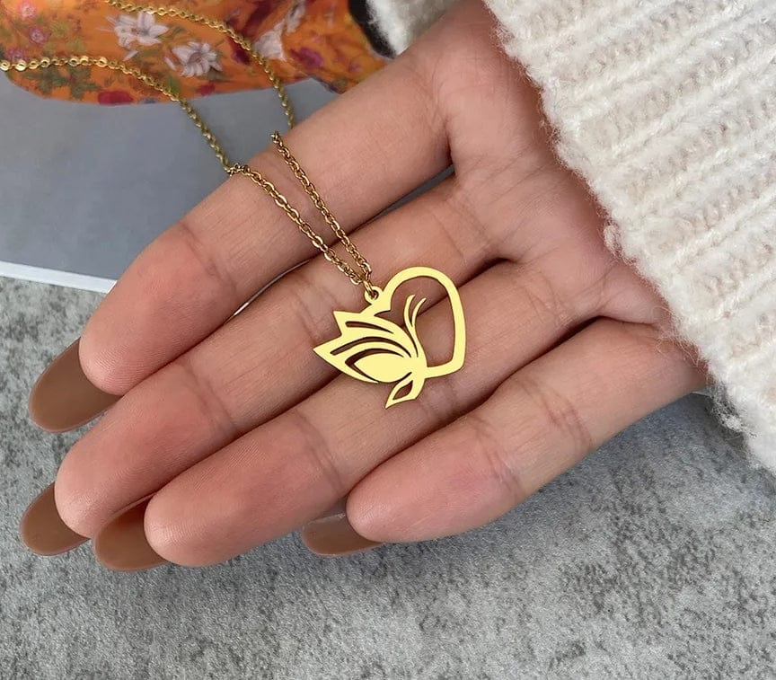 gold butterfly heart necklace in hand 
